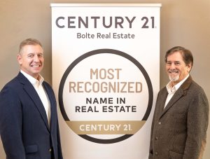image of Steve and Dave standing next to a Century 21 Most Recognized Sign